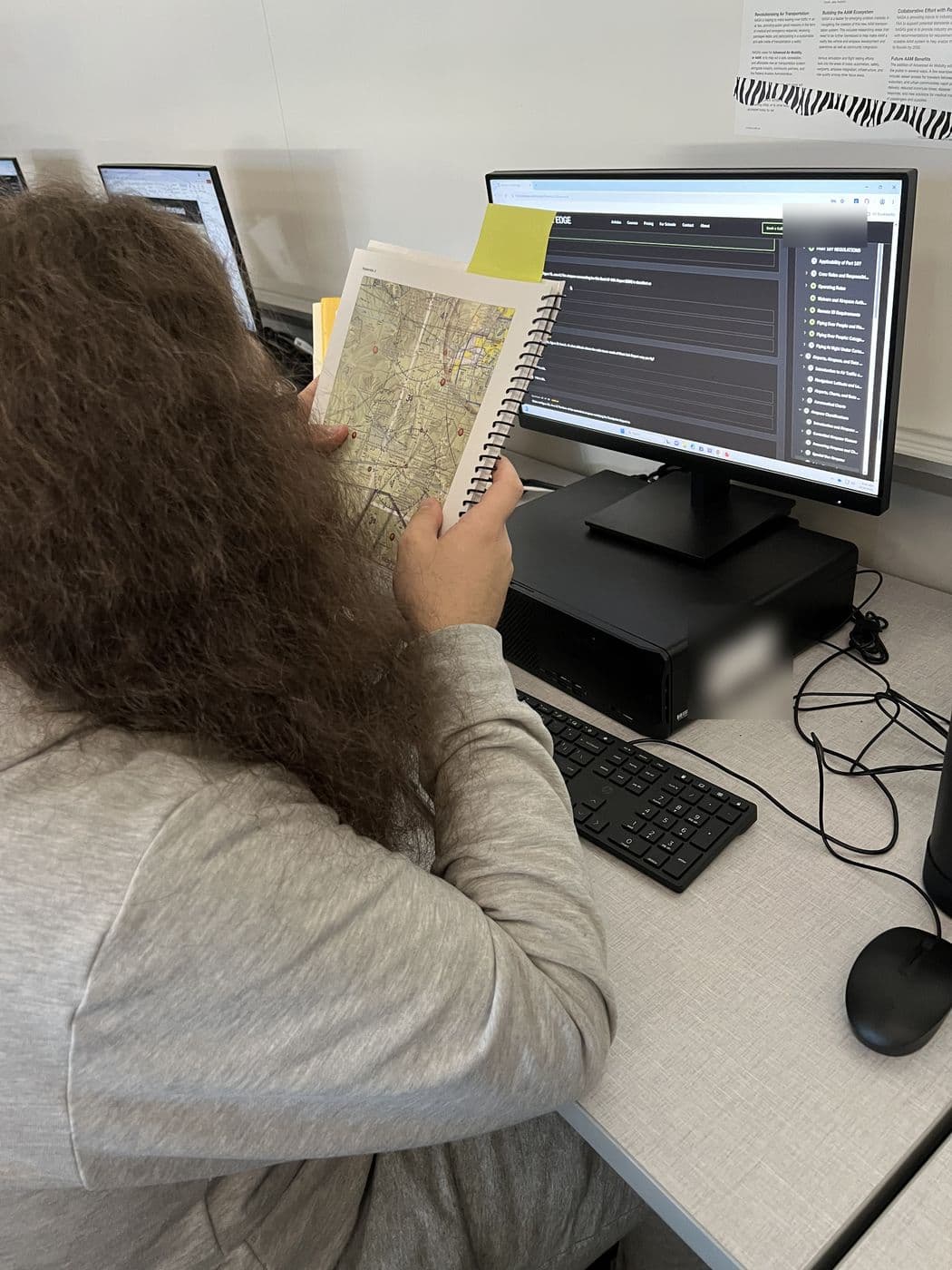A student compares a printed sectional chart with a Drone Edge lesson
